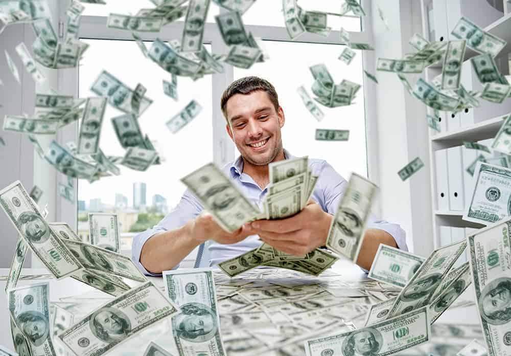 a man counting lots of 100 us dollar bill