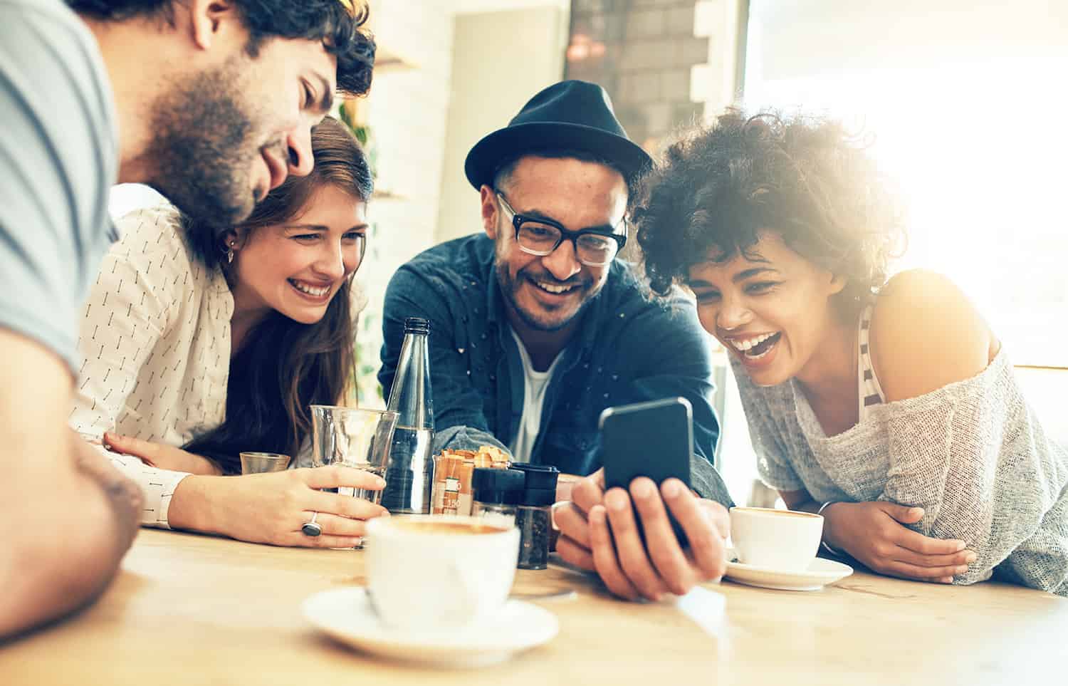 a person showing something from his mobile phone to his peers