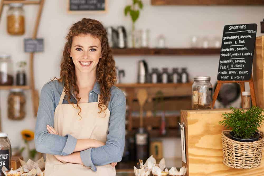 a women on a store selling smoothies